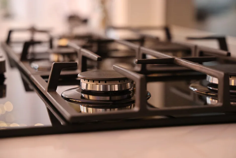 Close-up of the burners and cast iron trivets on a gas cooktop