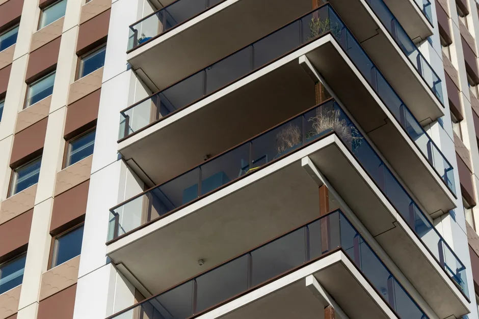 Glass balconies on the corner of a modern residential apartment tower