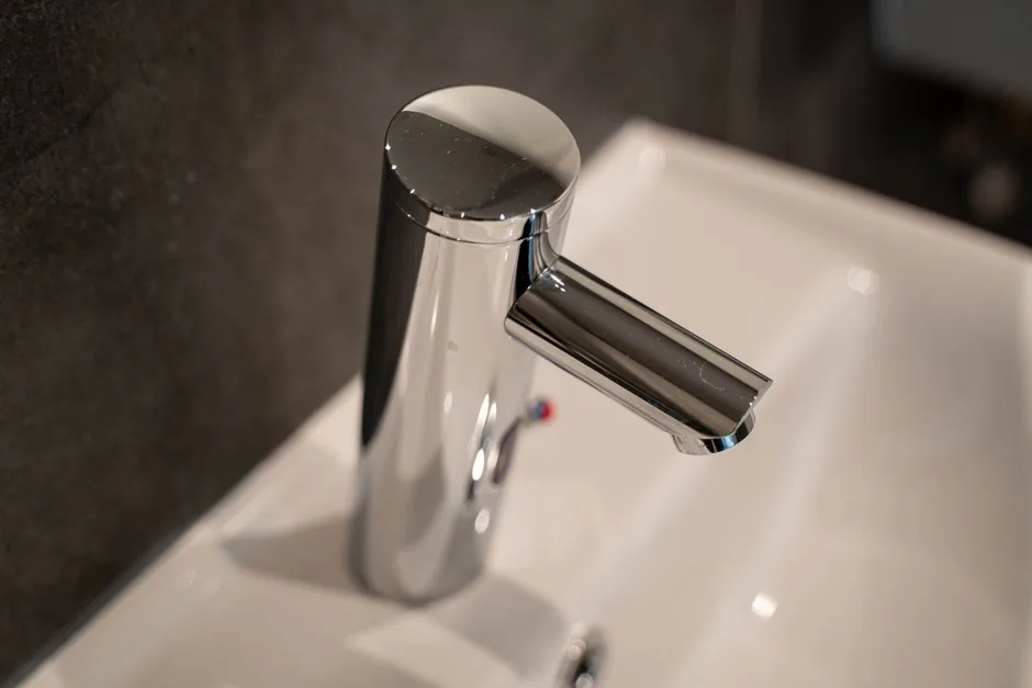 A chrome single lever mixer tap on a white ceramic basin